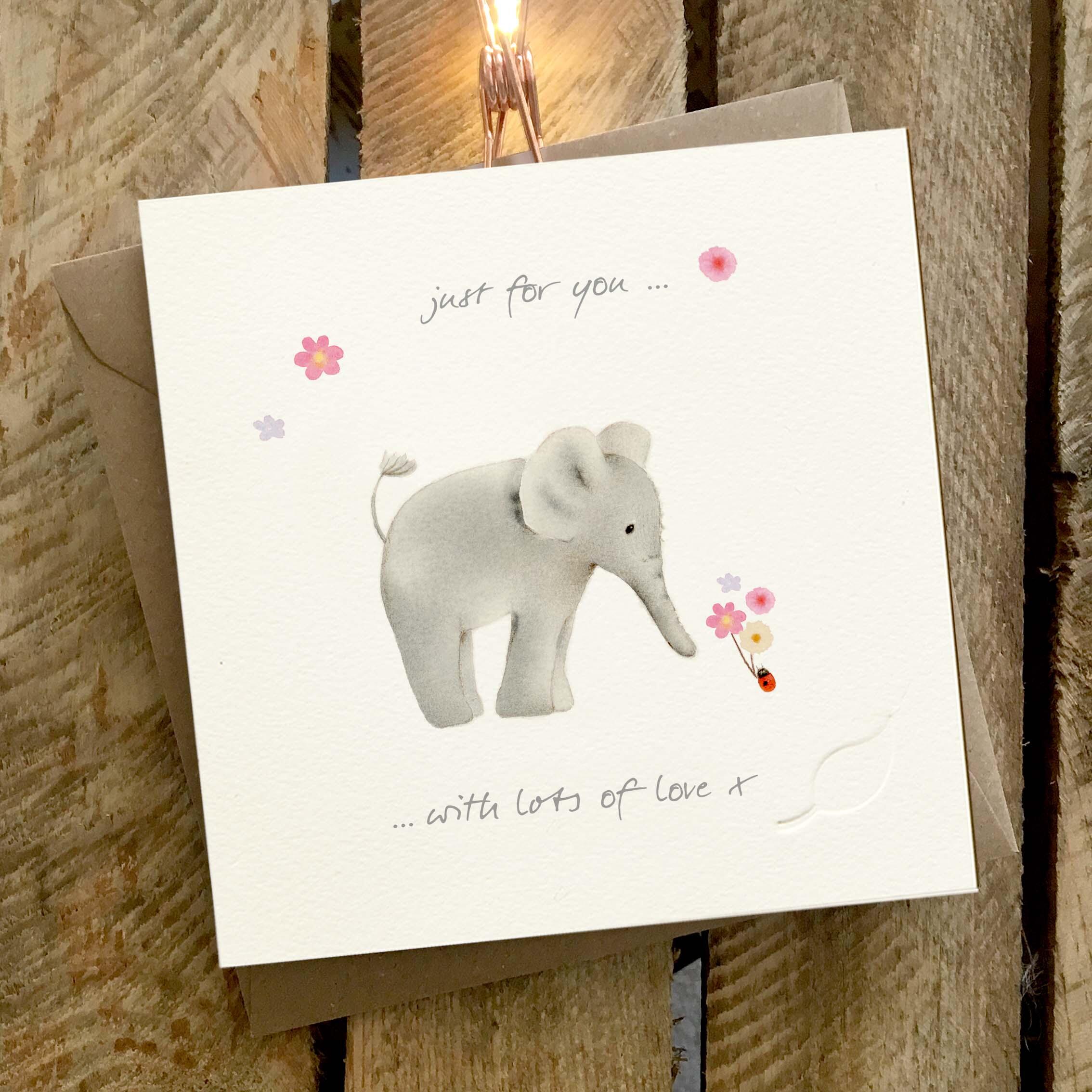 Elephant Family - Charity greeting card featuring a cute illustrated elephant, and a ladybird holding a bunch of flowers.