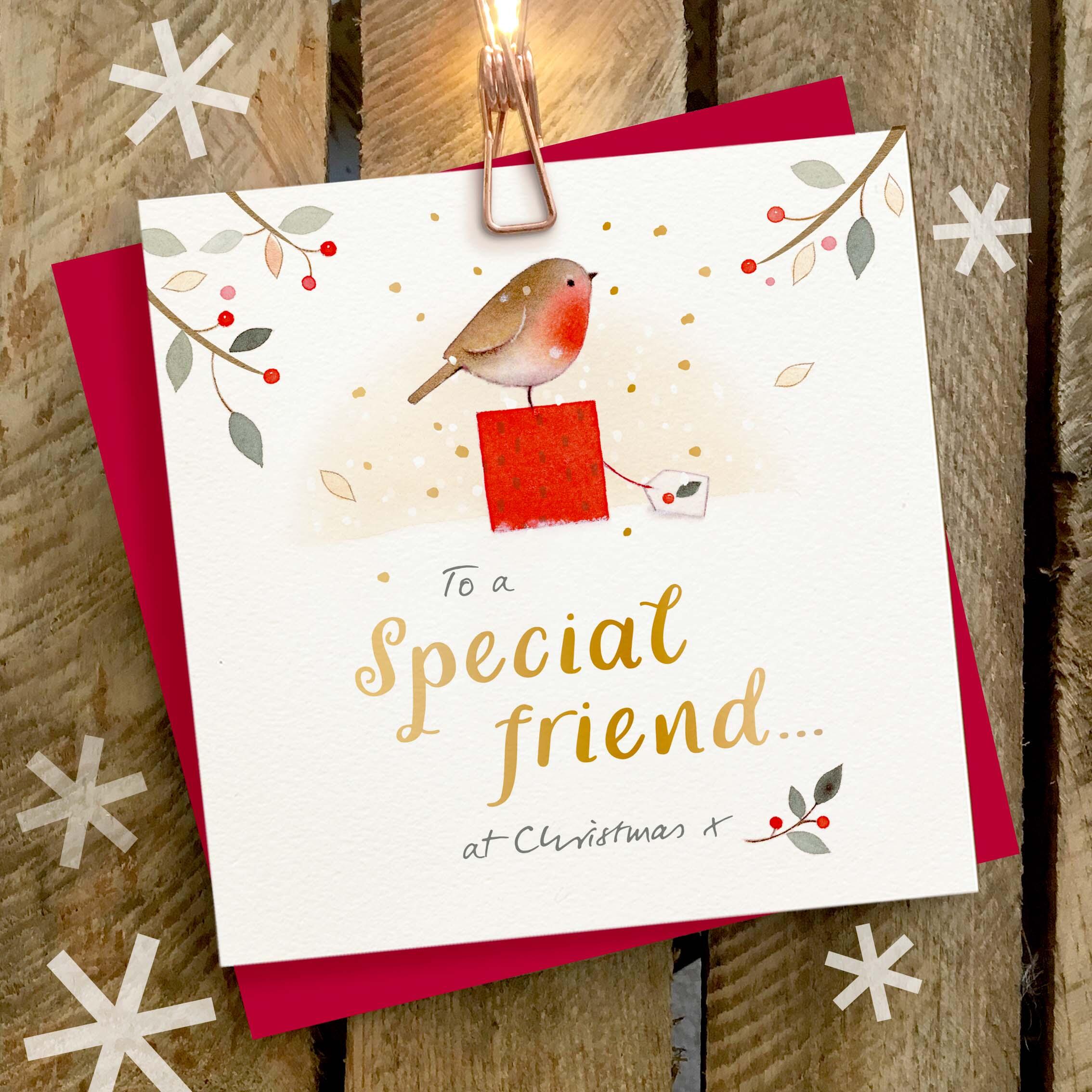 Christmas card featuring a large gold foil ‘Special Friend’ caption and a robin sat on top of a Christmas present.