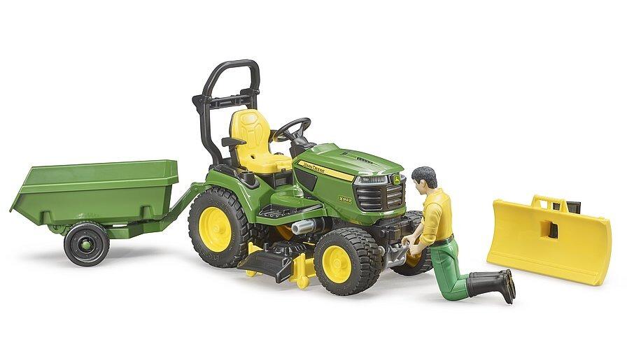 Gardener figure seated on Bruder John Deere tractor with mower deck