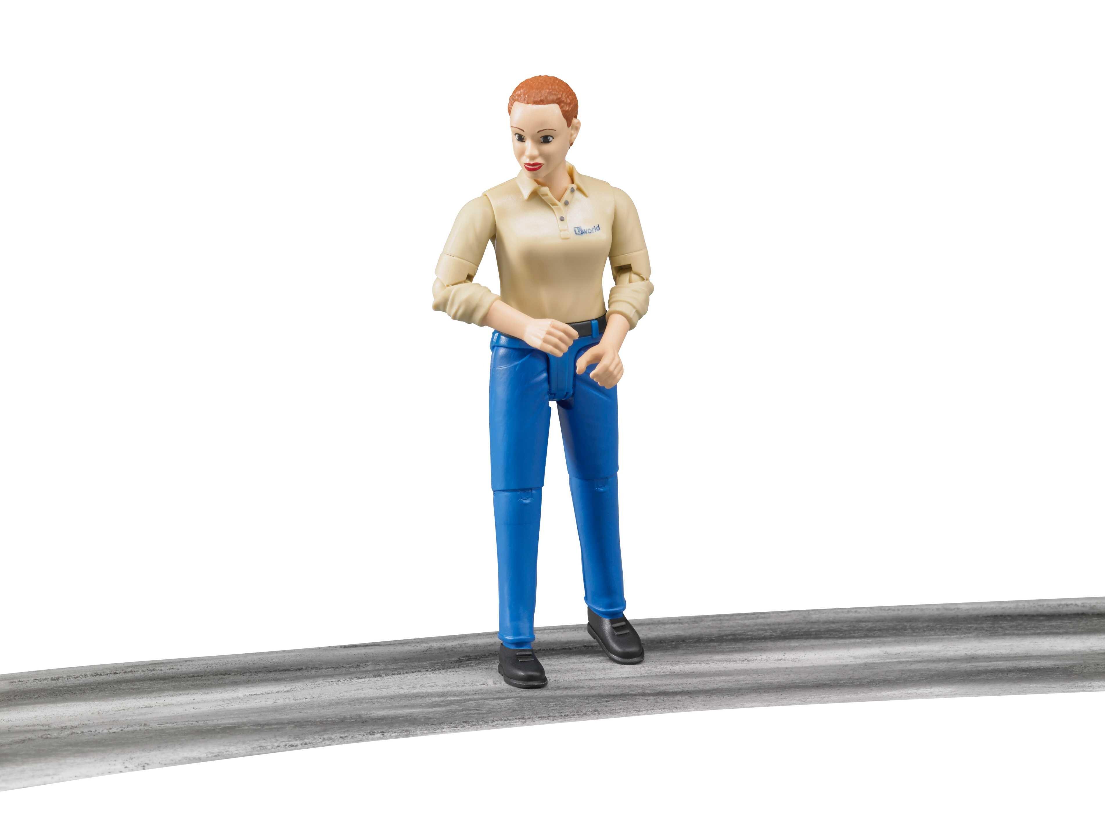 Bruder articulated woman figure in dark blue jeans posed on roadway surface