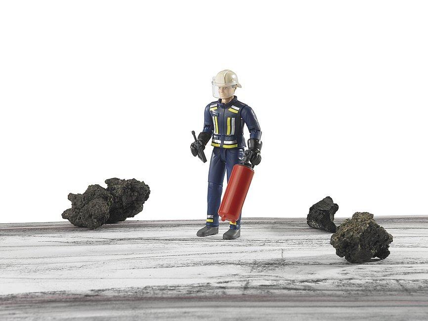 Bruder firefighter figure standing on debris with a fire extinguisher
