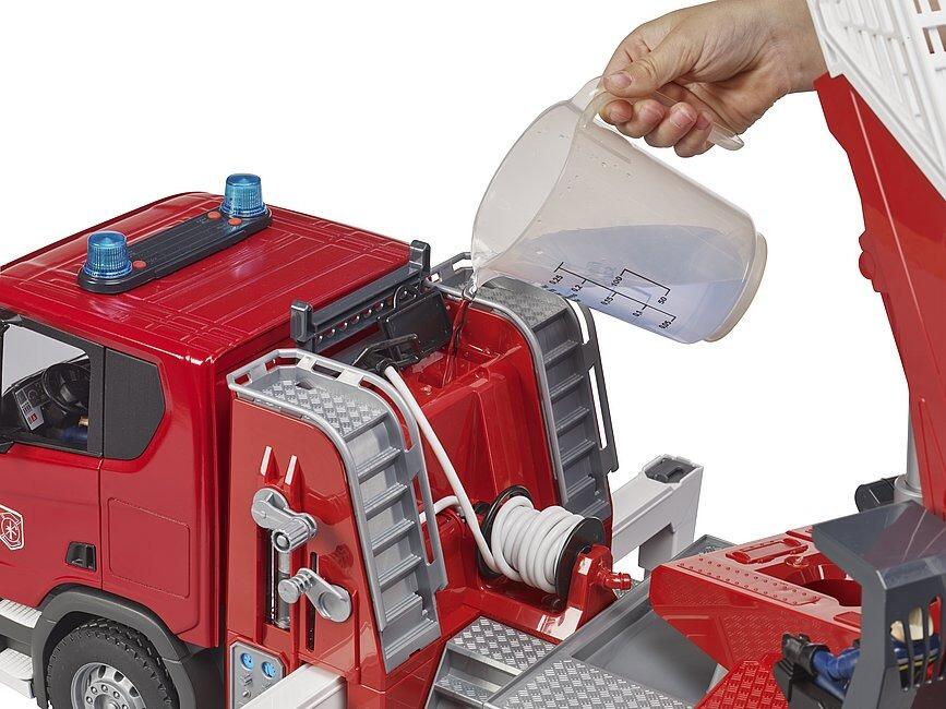 Child operating the water hose and features on the Scania fire engine toy