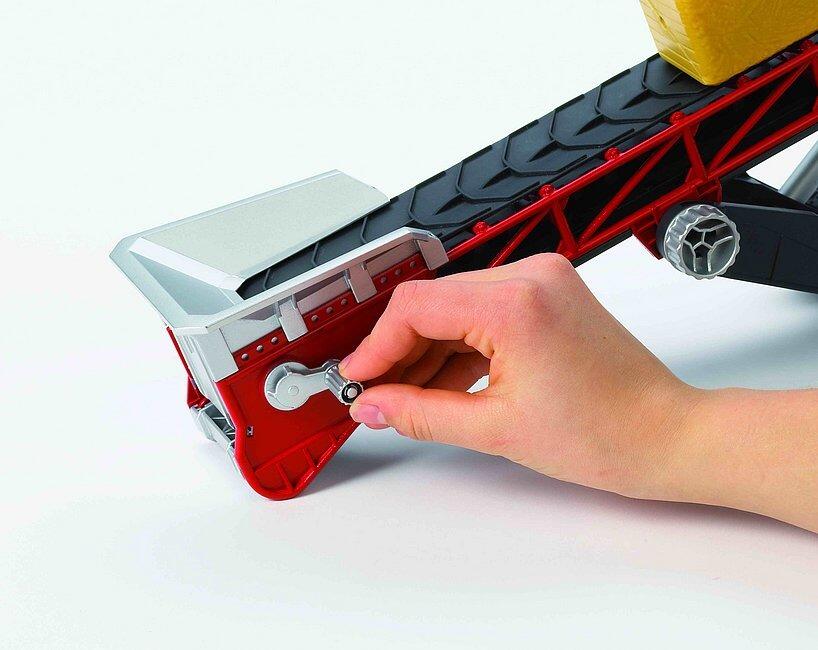 Child operating Bruder toy conveyor belt