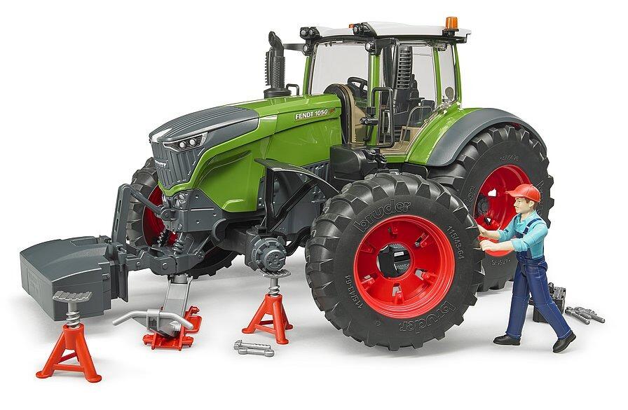 Mechanic working on Bruder Fendt 1050 Vario tractor with cones and tools