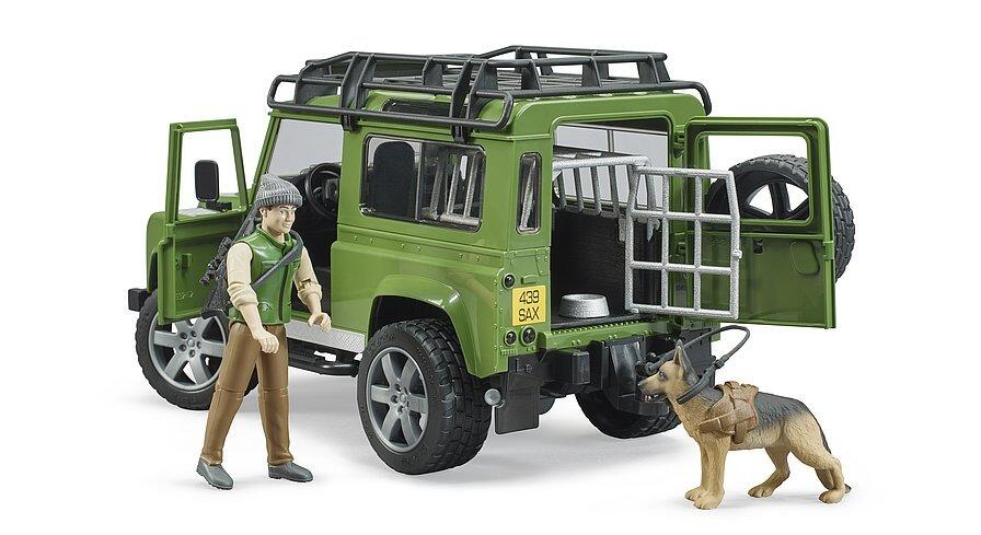 Forester figure unloading equipment from the back of the green vehicle with dog watching