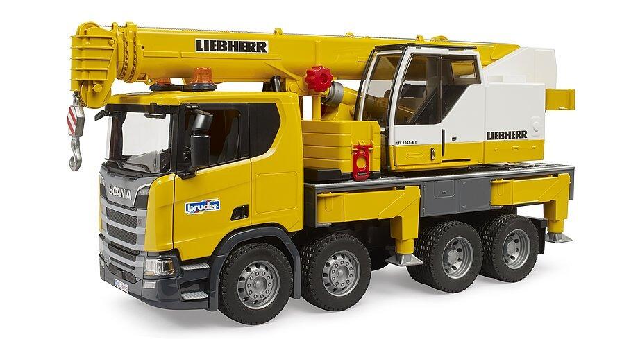 Rear view of the yellow crane truck showing crane housing and support legs
