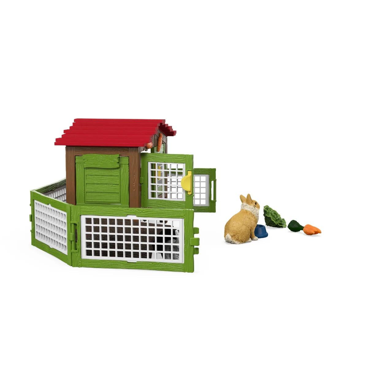 Schleich rabbit hutch with fenced run and rabbit figures positioned around the enclosure side view