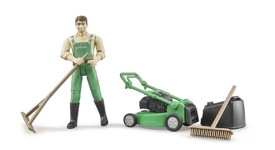 Gardener toy figure using rake alongside mower and accessories