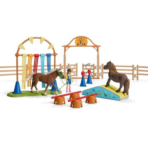 Schleich Pony Agility Training set with ponies, child figure, cones and agility obstacles arranged in an enclosed arena.