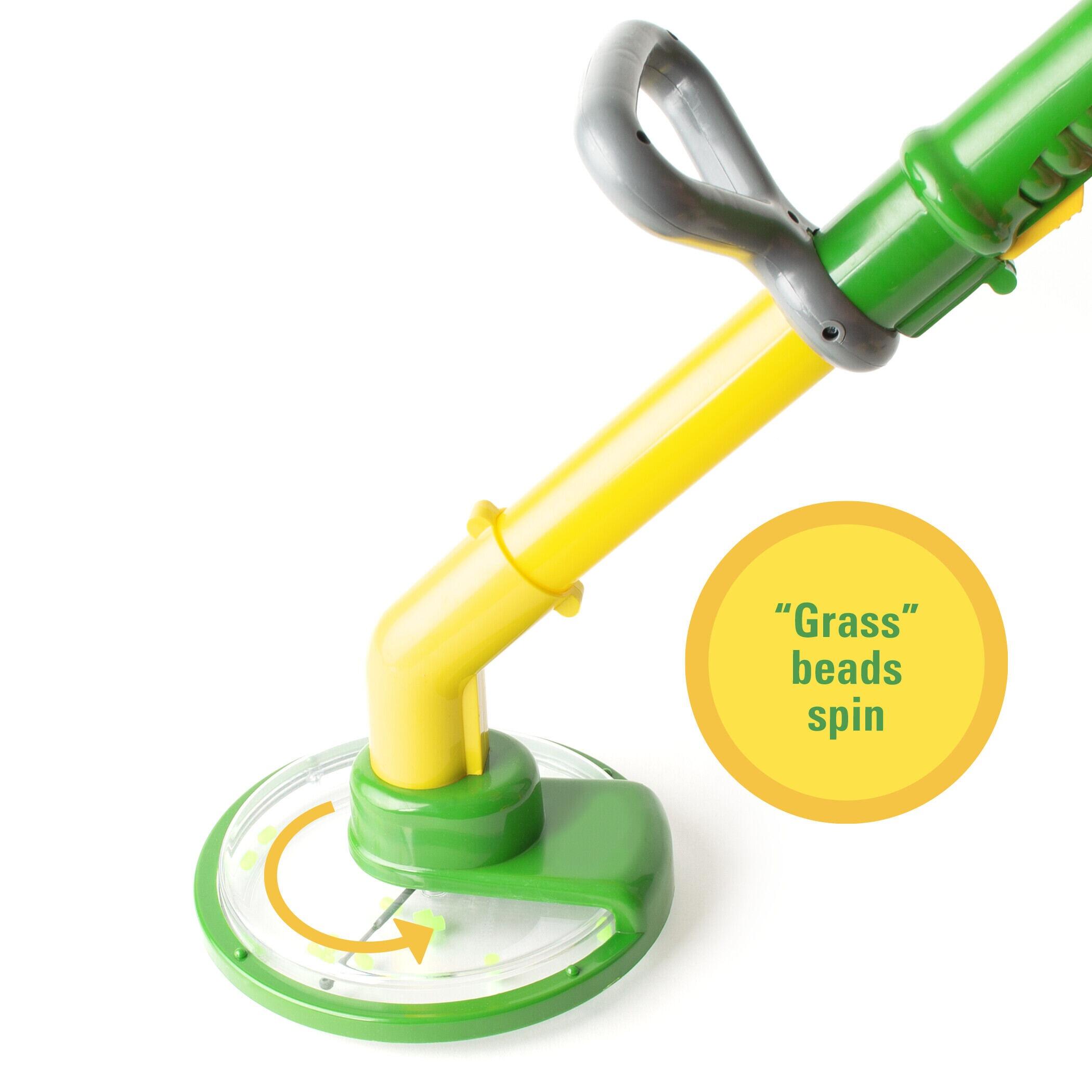 Angled view of the John Deere kids’ toy power trimmer lying on a white background.