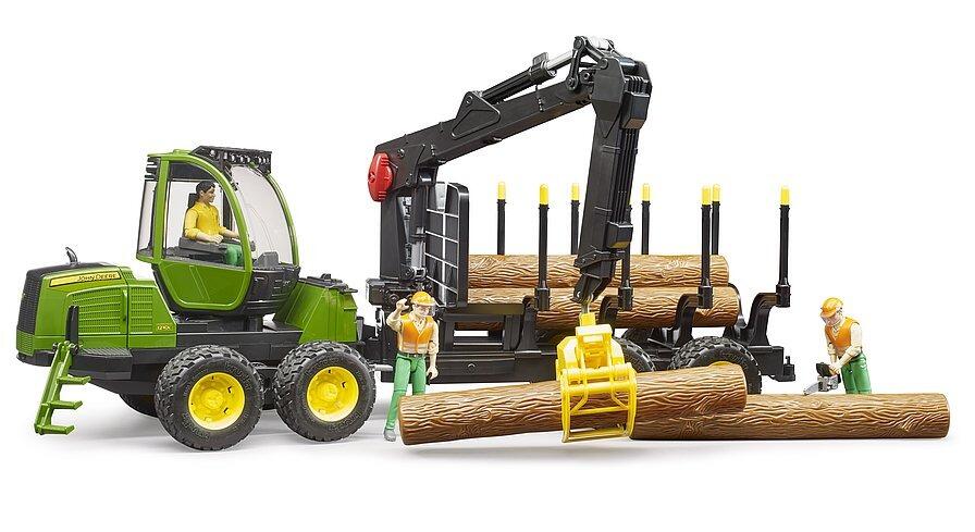 Green log-loading machine with crane arm raised above stacked logs on the rear platform