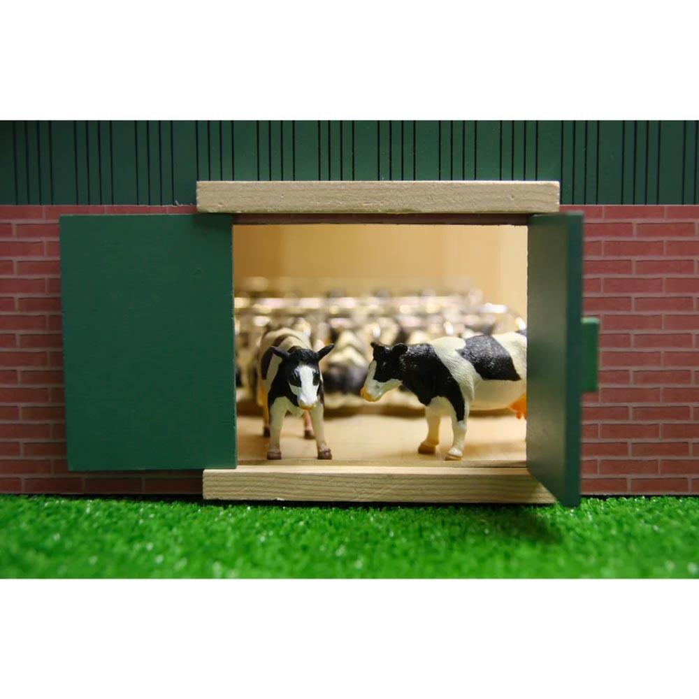 Front view of the Kids Globe 1:32 cattle shed showing cows standing inside the barn through the open doorway.