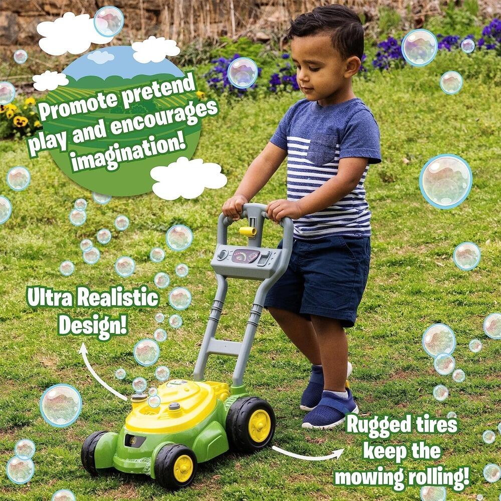Child pushing a John Deere bubble mower outdoors with bubbles floating around