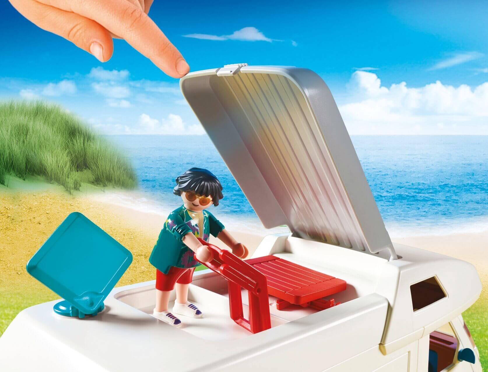 Playmobil figure folding deckchair on roof of van