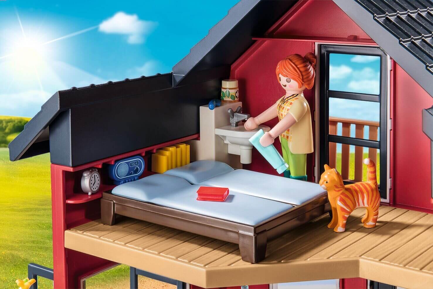 Playmobil farmhouse bedroom scene with figure, cat and detailed upper floor room from set 71248