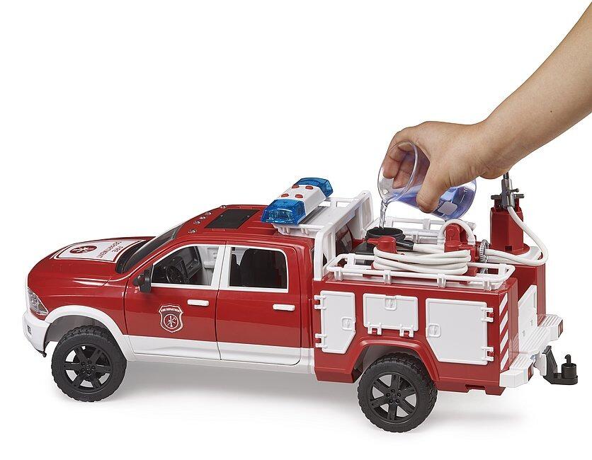 Child lifting the water tank compartment lid on the red RAM fire engine toy