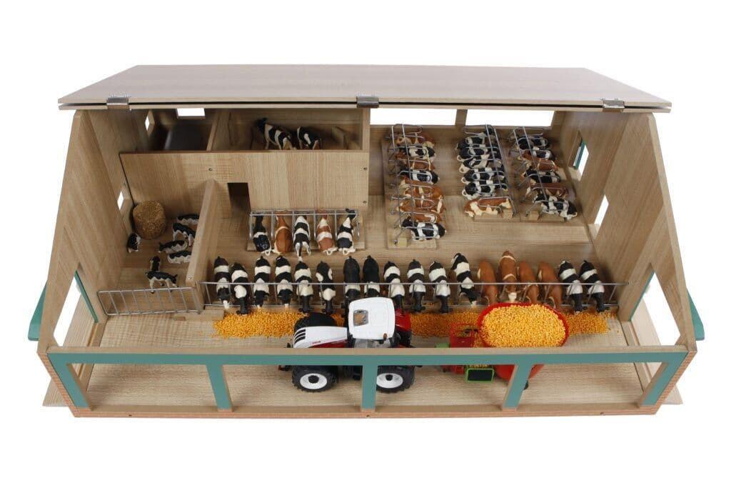 Overhead interior view of the Kids Globe 1:32 cattle shed with milking parlour, showing stalls, equipment and cattle figures.