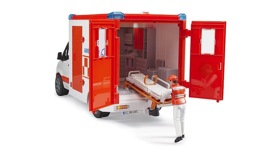 Rear view of Bruder toy ambulance with back doors open and stretcher inside
