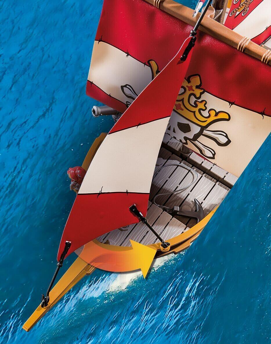 Overhead view of PLAYMOBIL 71418 Pirate Ship with red and black sails on blue water