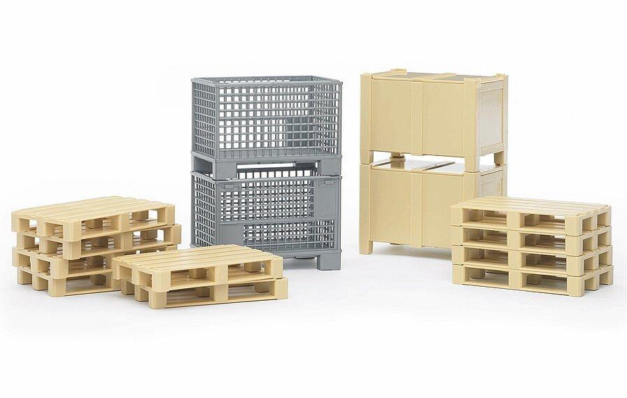 Bruder logistics toy set with Euro pallets, mesh boxes and cable drums on a white background