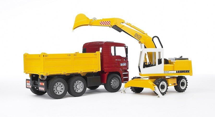 Side view of Bruder MAN TGA tipper truck towing Liebherr excavator 1:16 scale construction toy set
