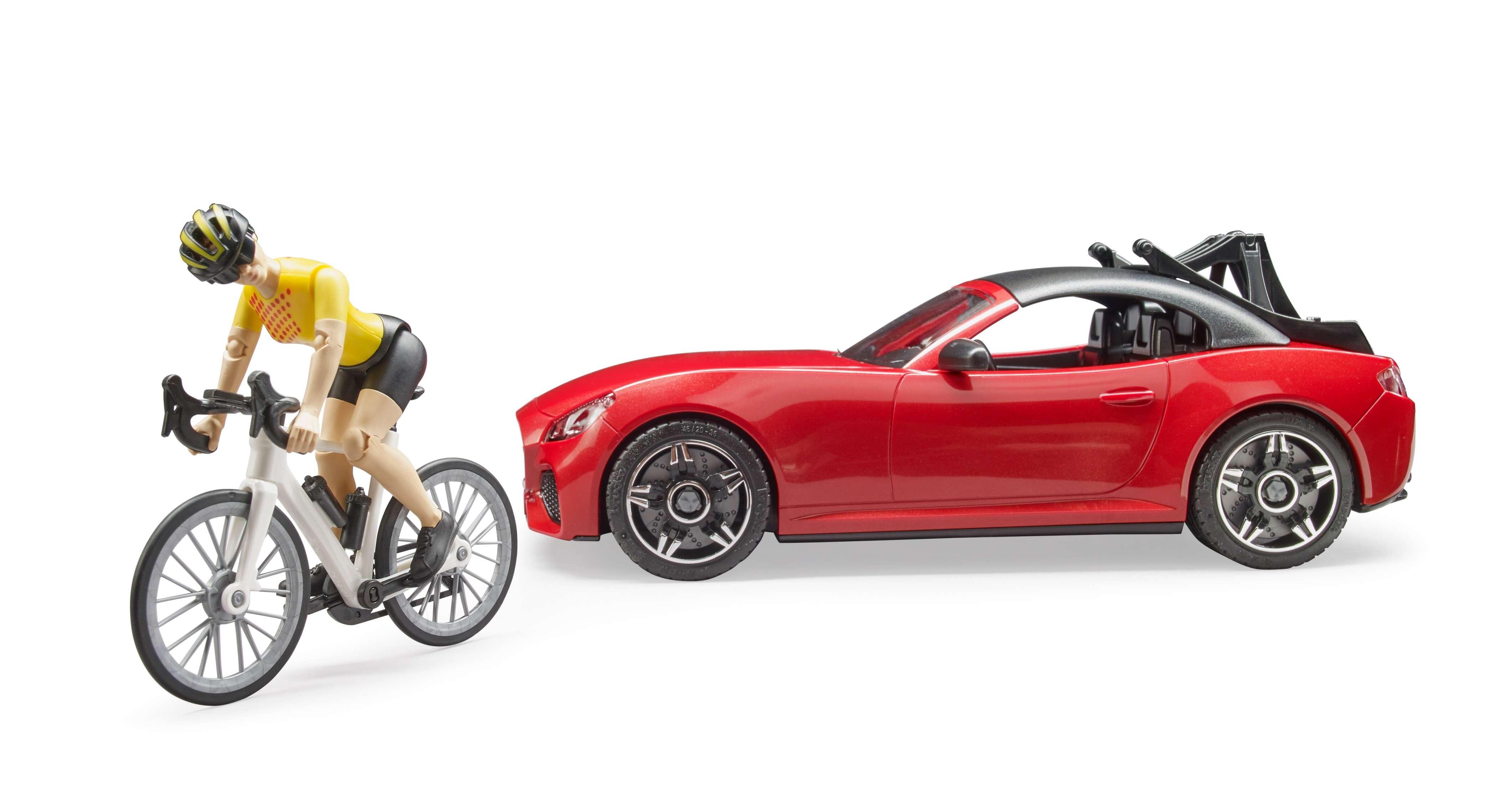 Bruder Roadster toy car with cyclist figure standing beside vehicle – front angle