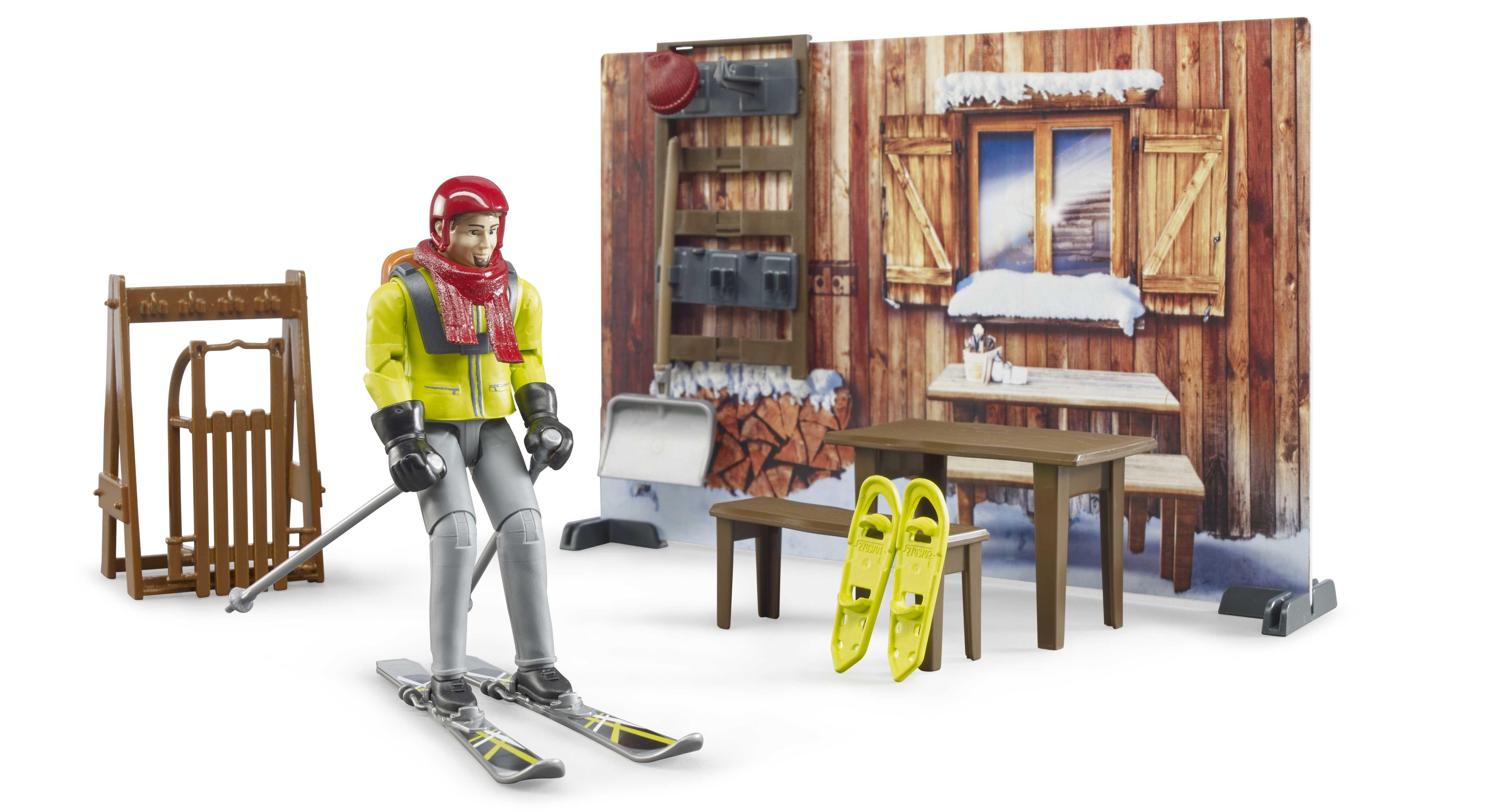 Bruder Mountain Hut playset – skier figure outside wooden cabin with snow gear and furniture