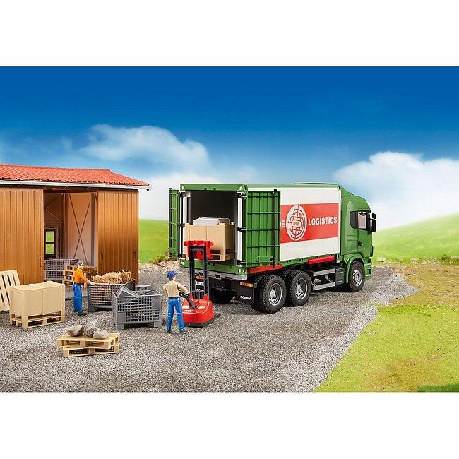 Bruder logistics accessories being used with a toy truck in a warehouse play scene