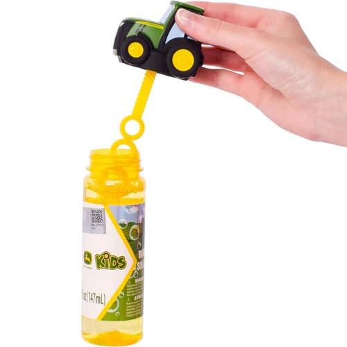 Hand holding John Deere bubble bottle wand