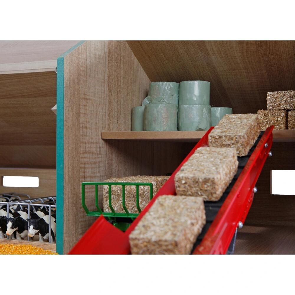 Internal view of a conveyor belt transporting hey to the upper level of the shed.