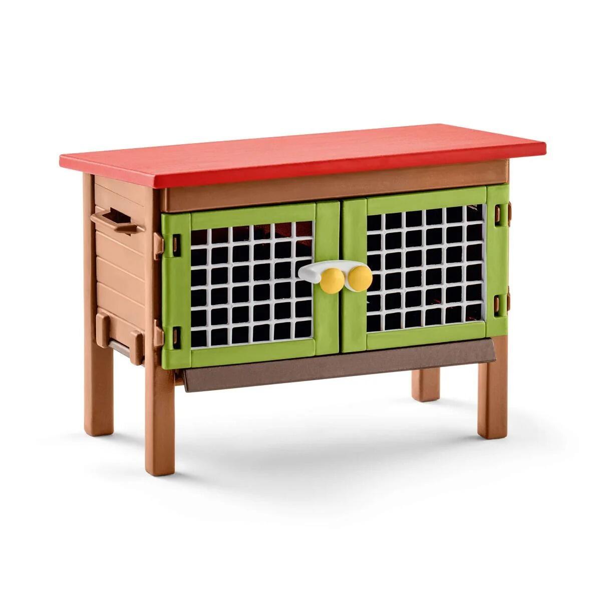Schleich rabbit hutch with red roof and green mesh doors.