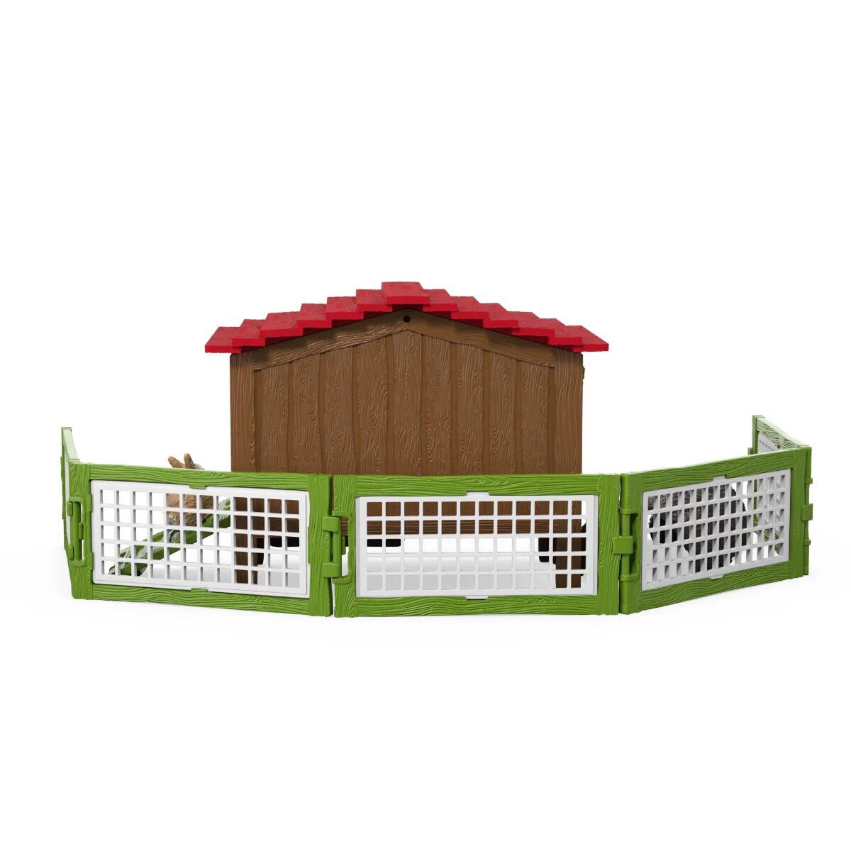 Schleich rabbit hutch with red roof and full green fenced run shown from the front.