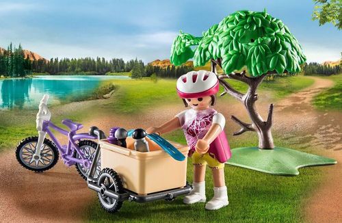 Playmobil mountain biker figure standing with bike on a woodland path