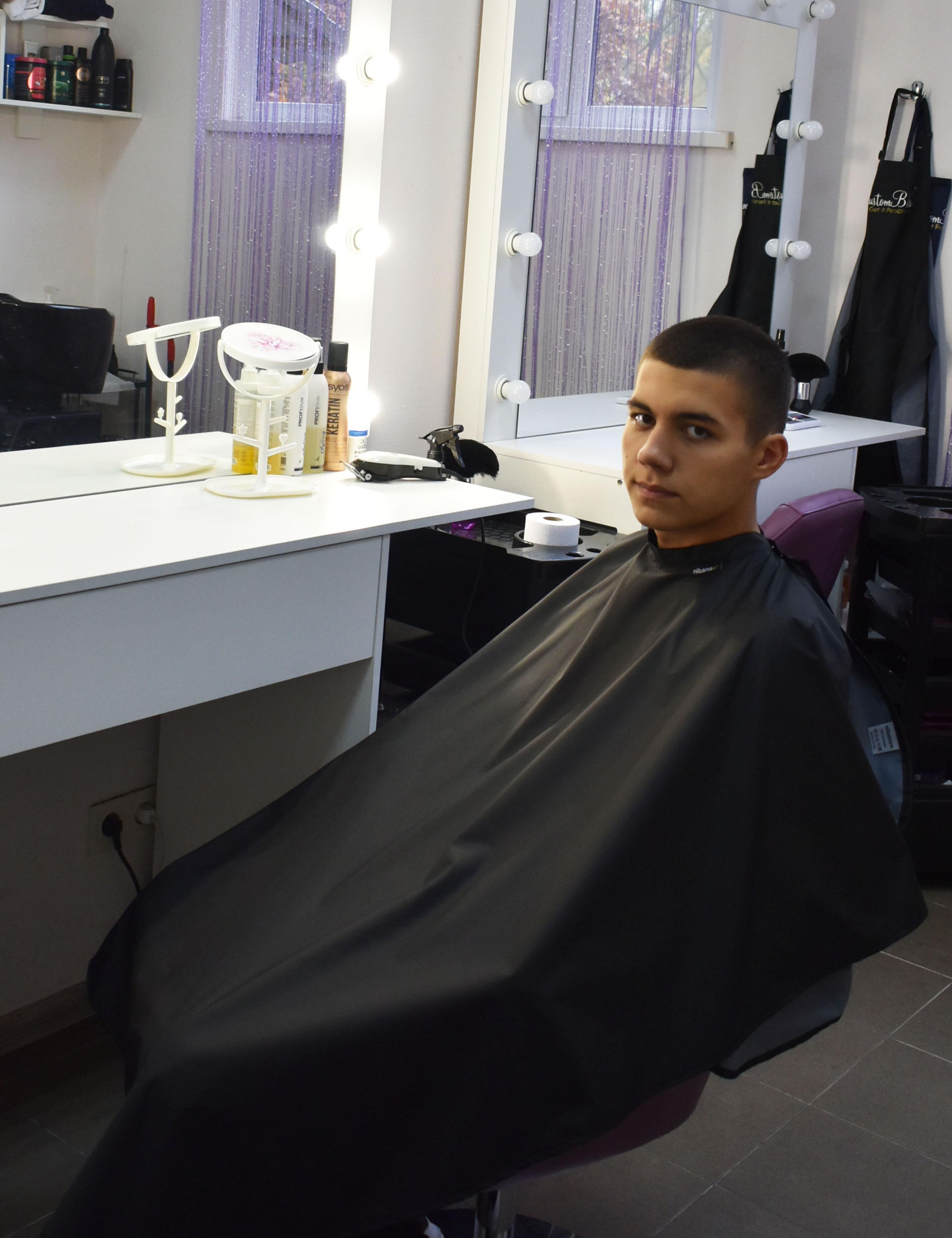 Premium embroidered black salon cape for professional barbershops
