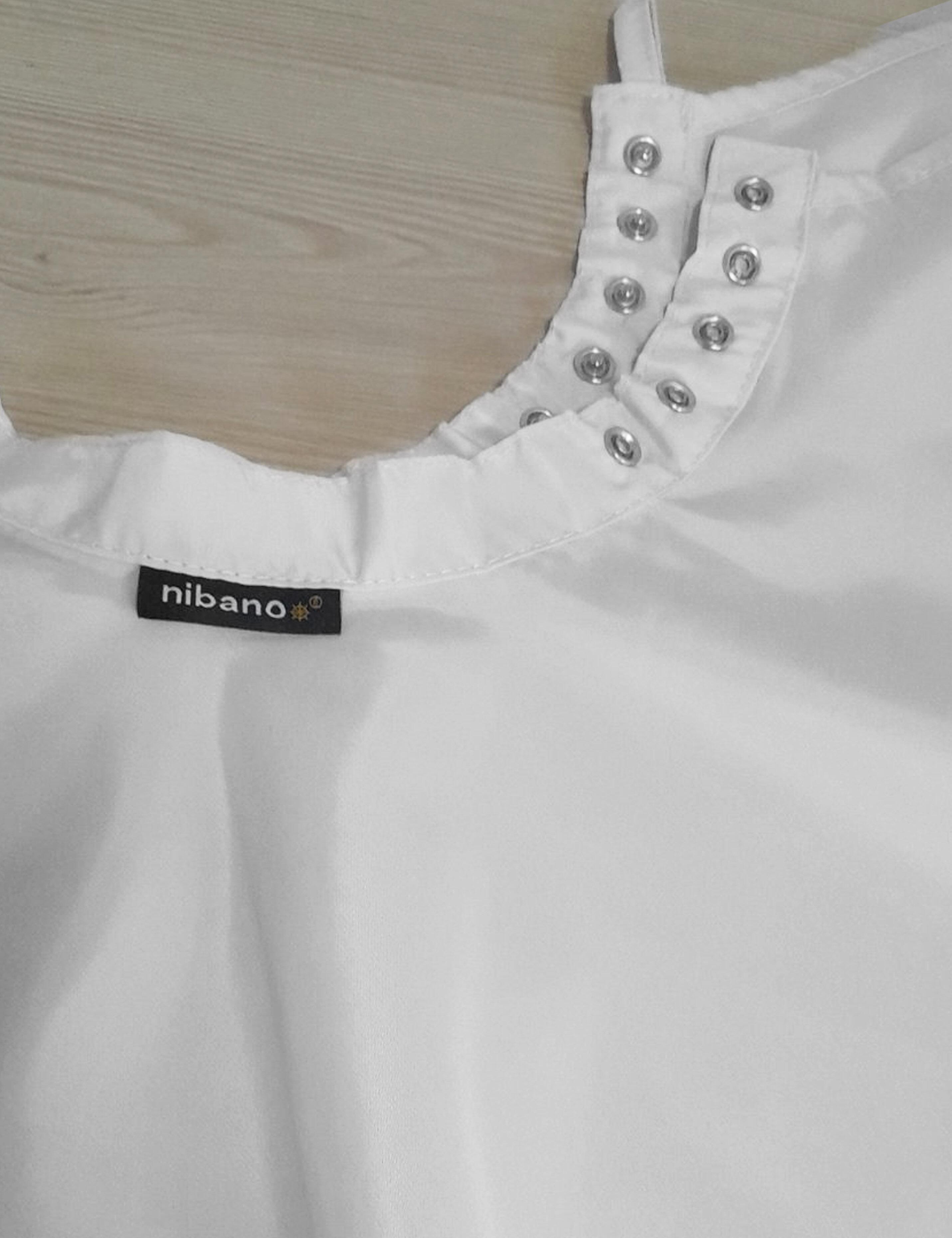 White salon cape with adjustable snap closures for a secure neck fit