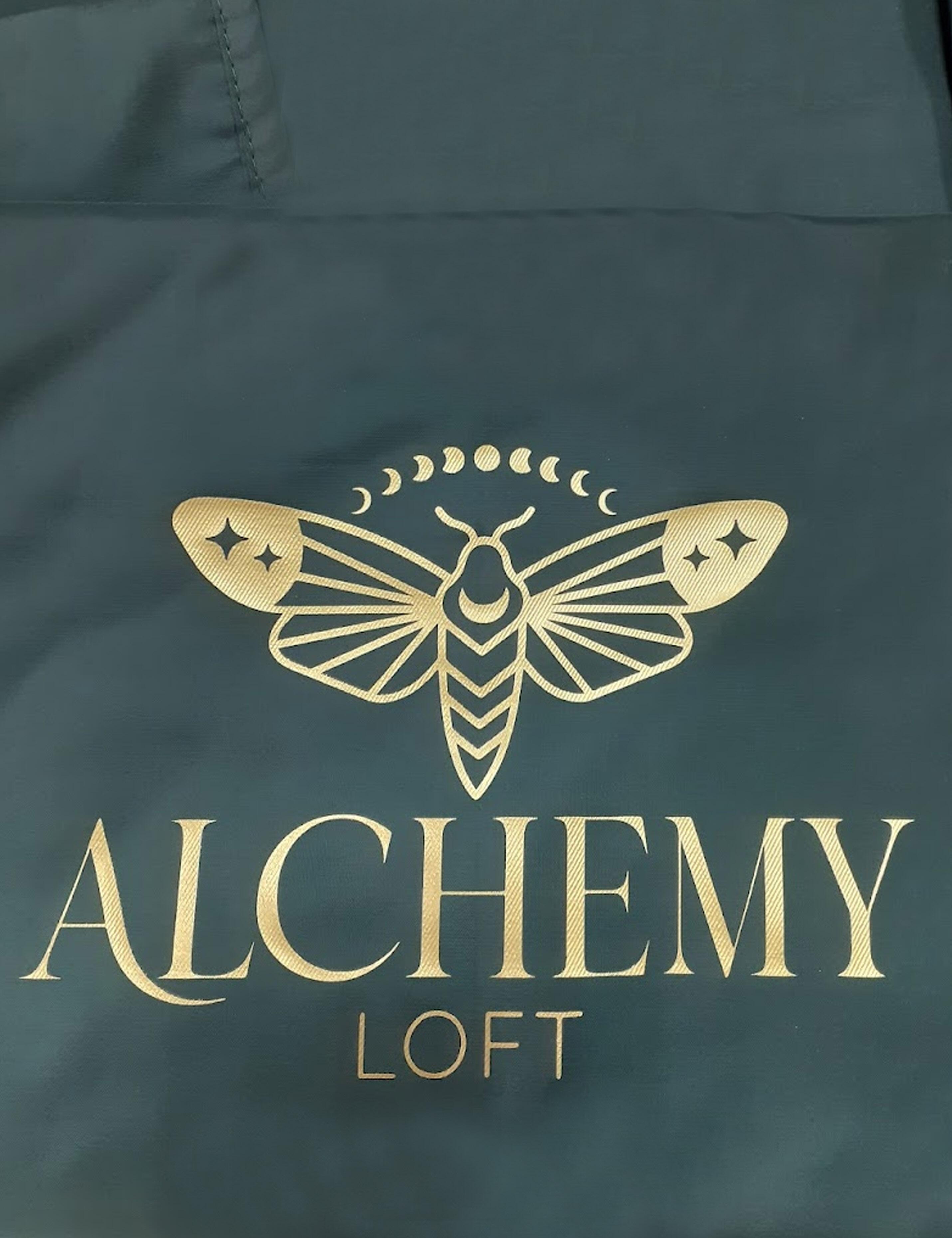 Custom printed bottle green salon cape featuring a personalized hairdresser logo