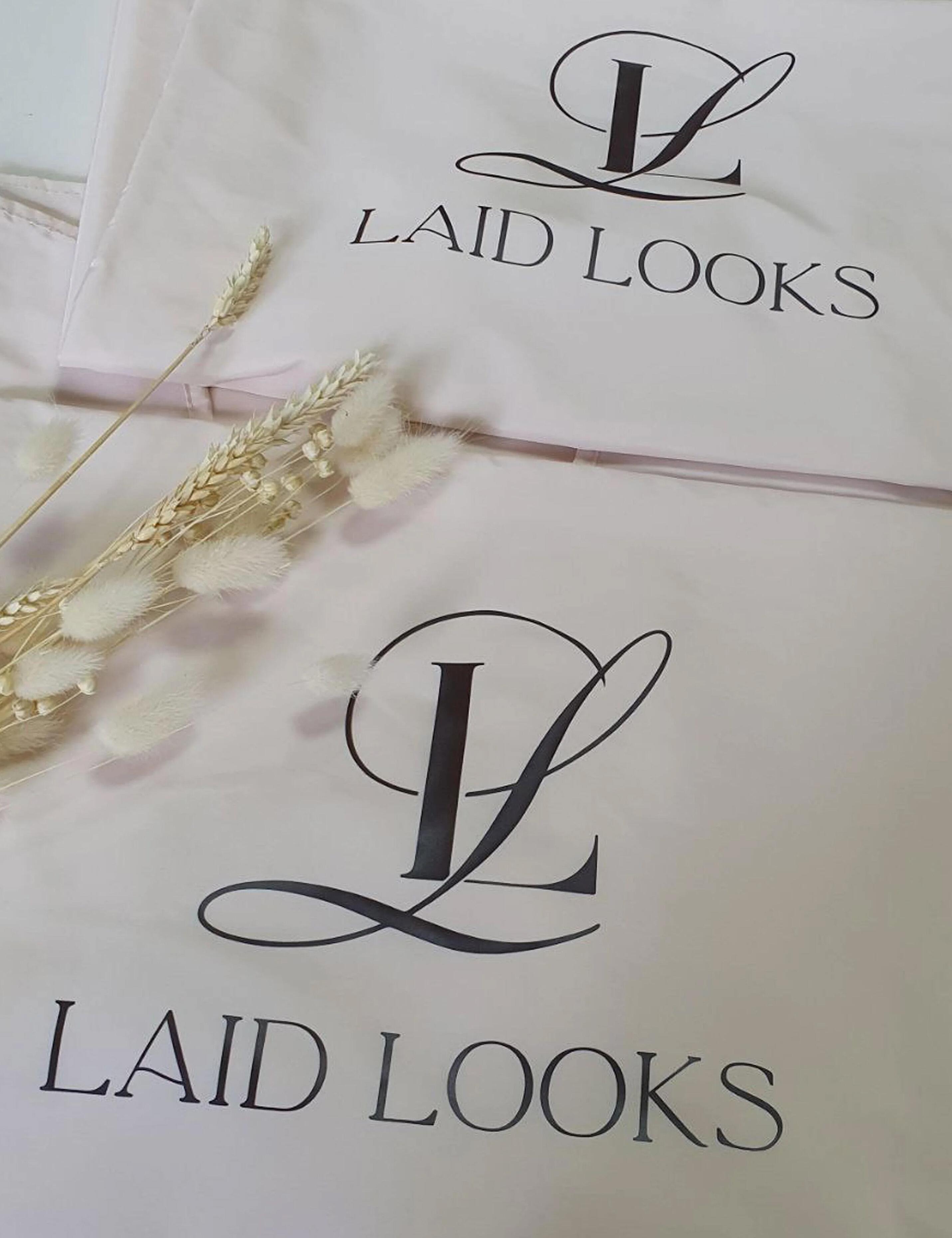 Custom printed cream salon cape with a personalized hairdresser logo