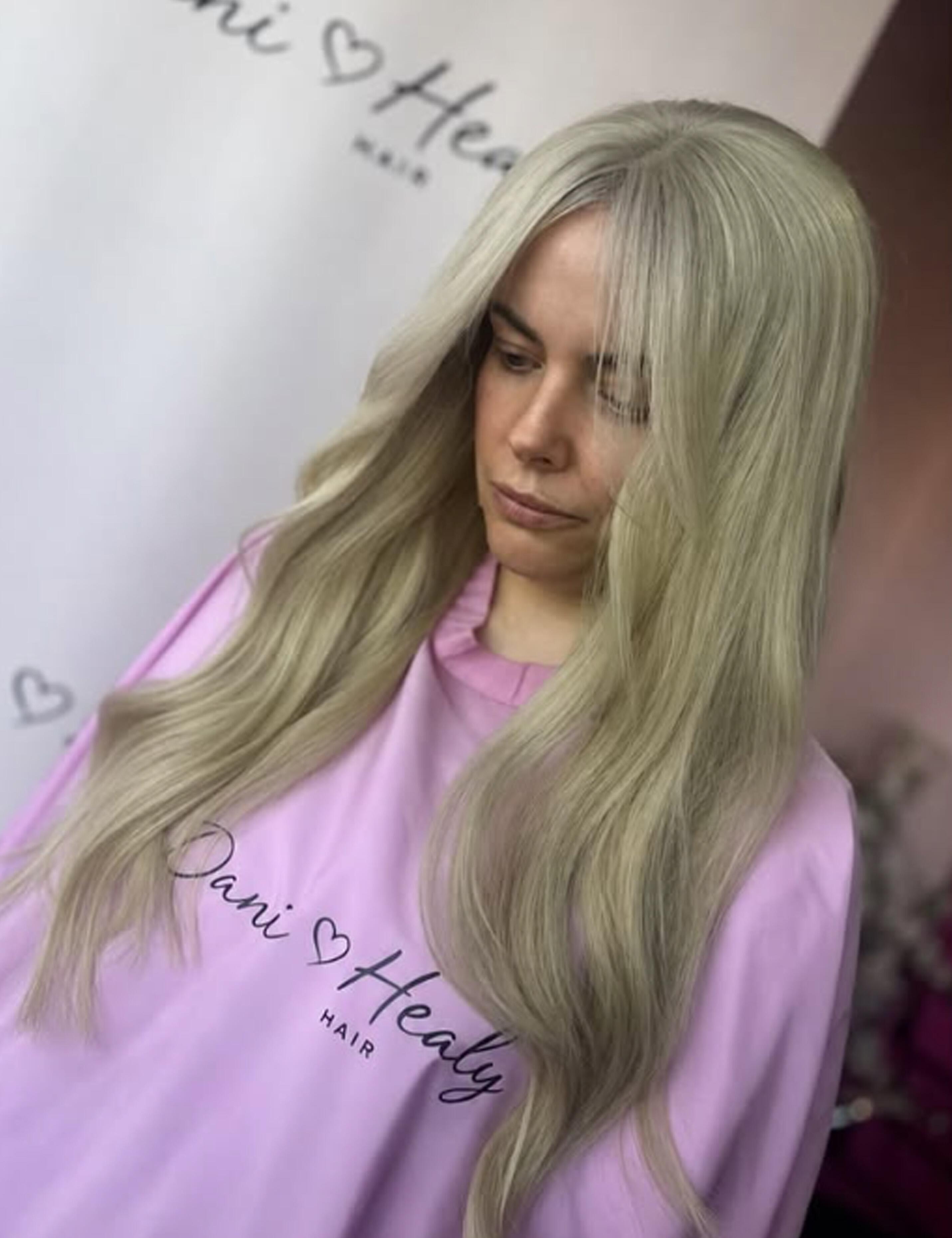 Custom printed pink salon cape with a personalized hairdresser logo.