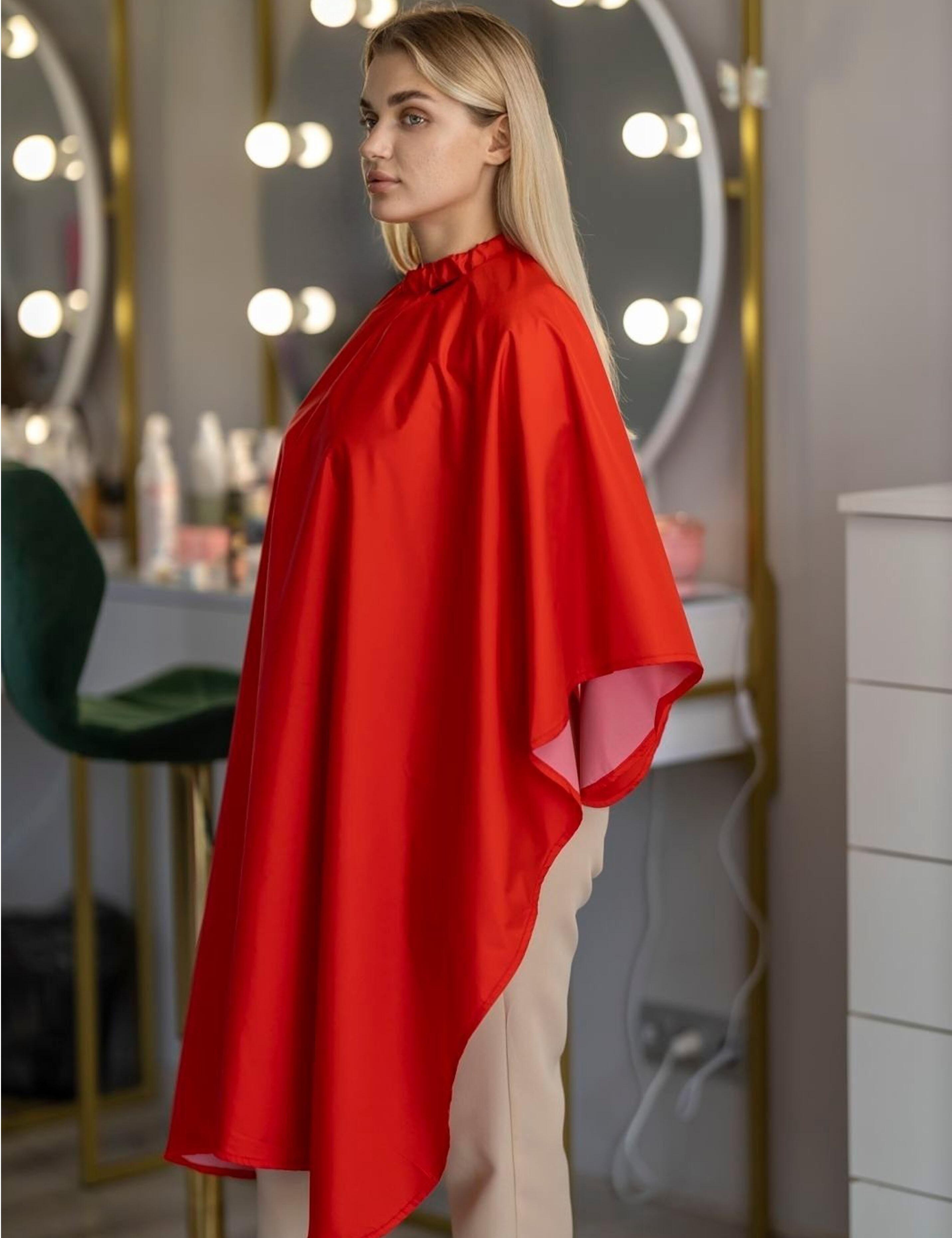 Full-coverage red color cape ensuring ultimate client protection and comfort.