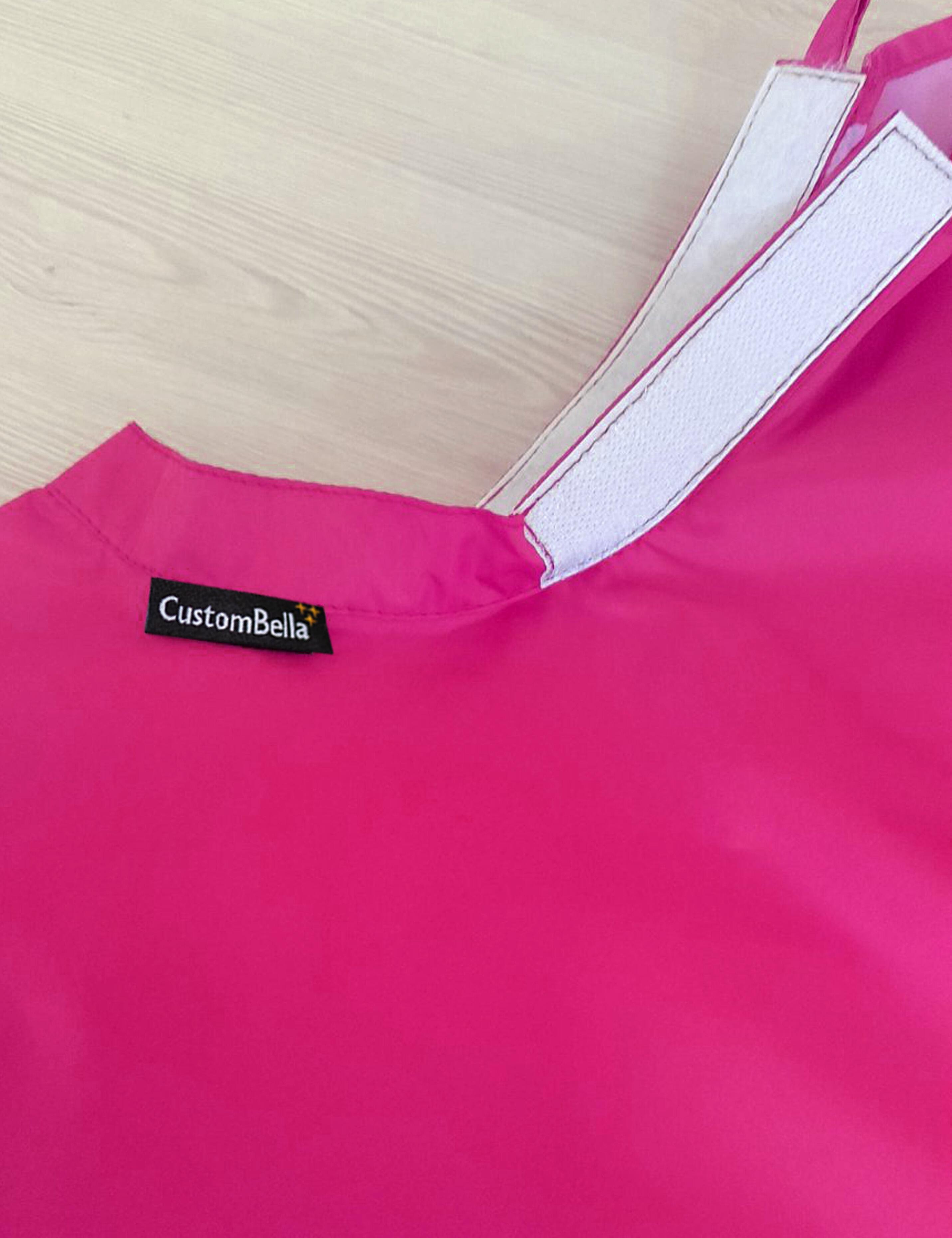 Hot pink kids salon cape with an adjustable velcro neck closure