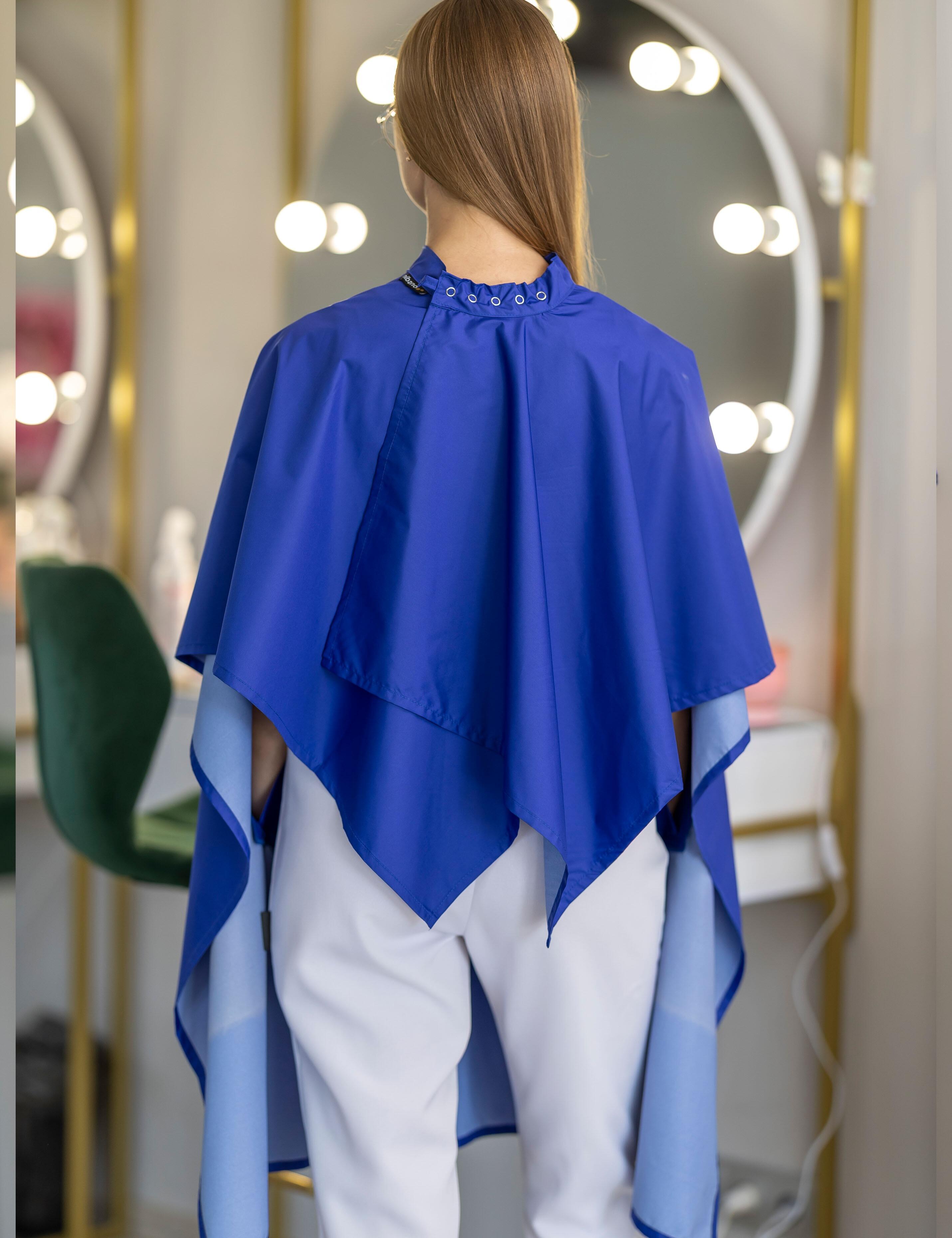 Royal blue salon cape with arm slits for barbers and stylists