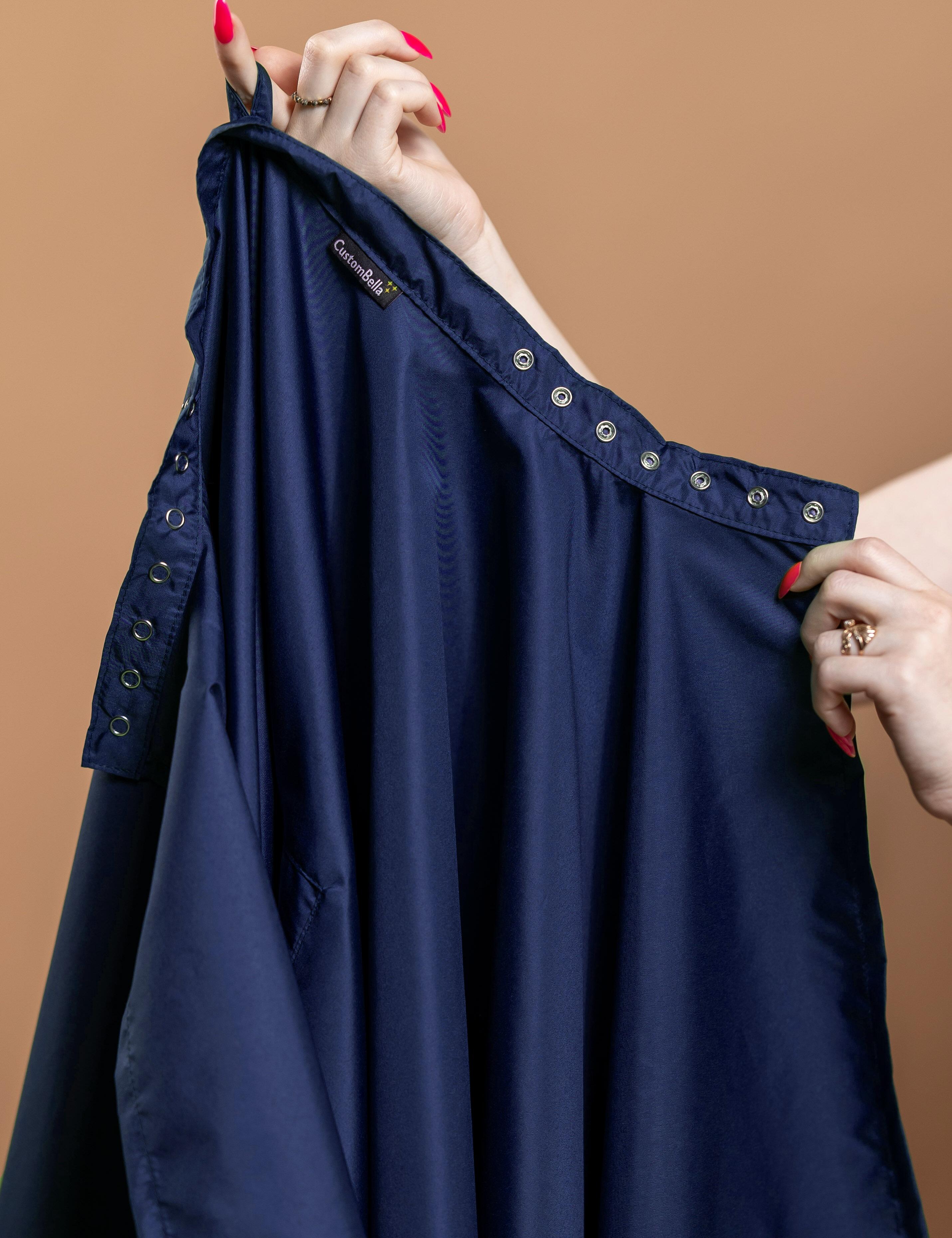 Navy blue salon cape with hand slits and adjustable snap button closure