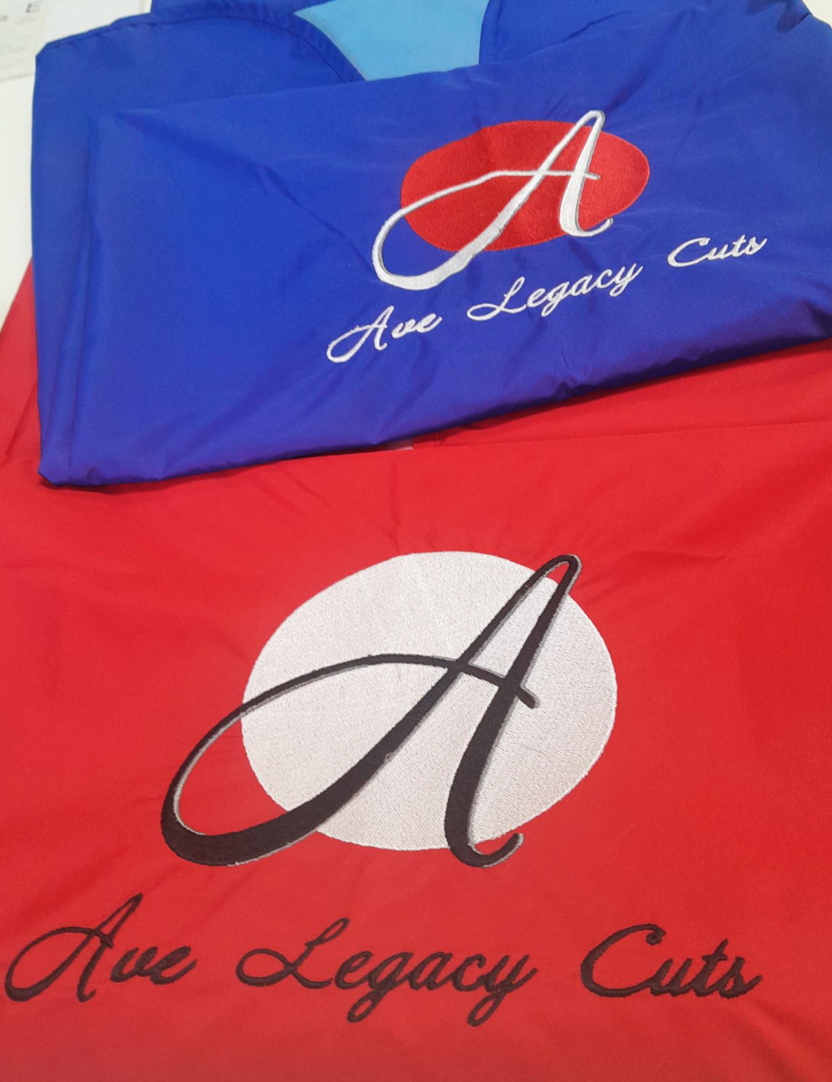 Embroidered royal blue salon cape with hand slits and logo