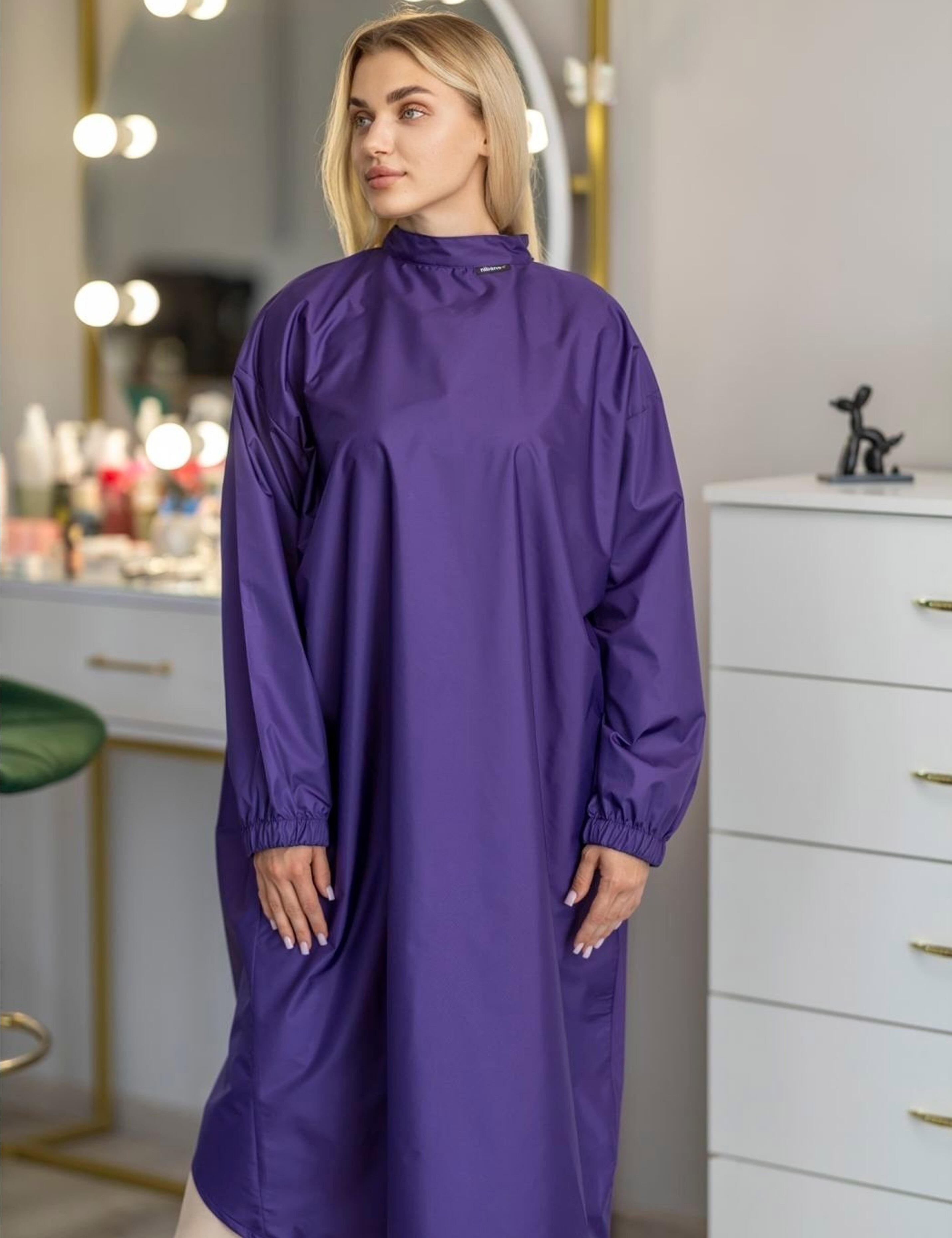 Vibrant purple salon styling cape featuring built-in sleeves for total client mobility and phone use