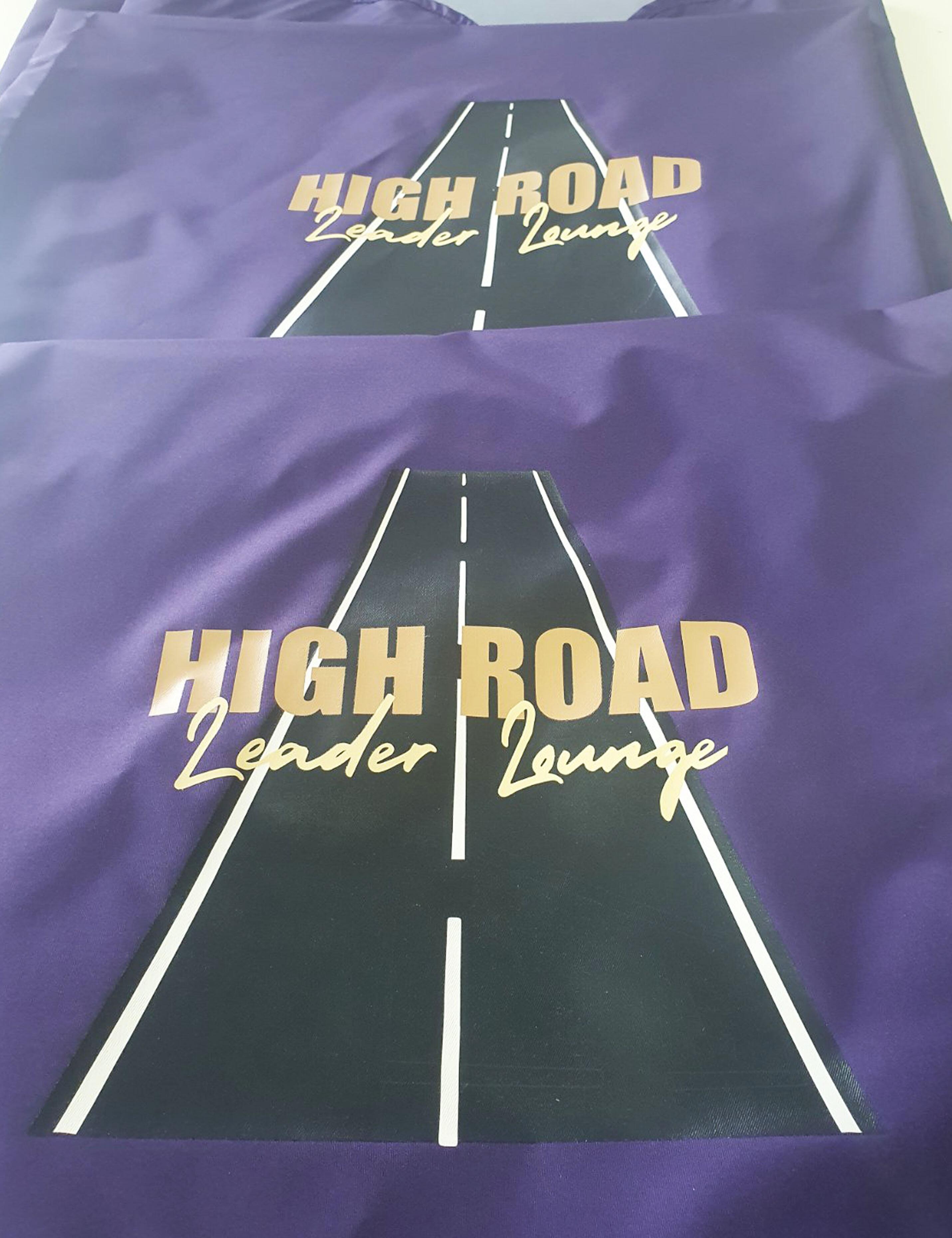 Custom printed purple salon cape with a personalized hairdresser logo.
