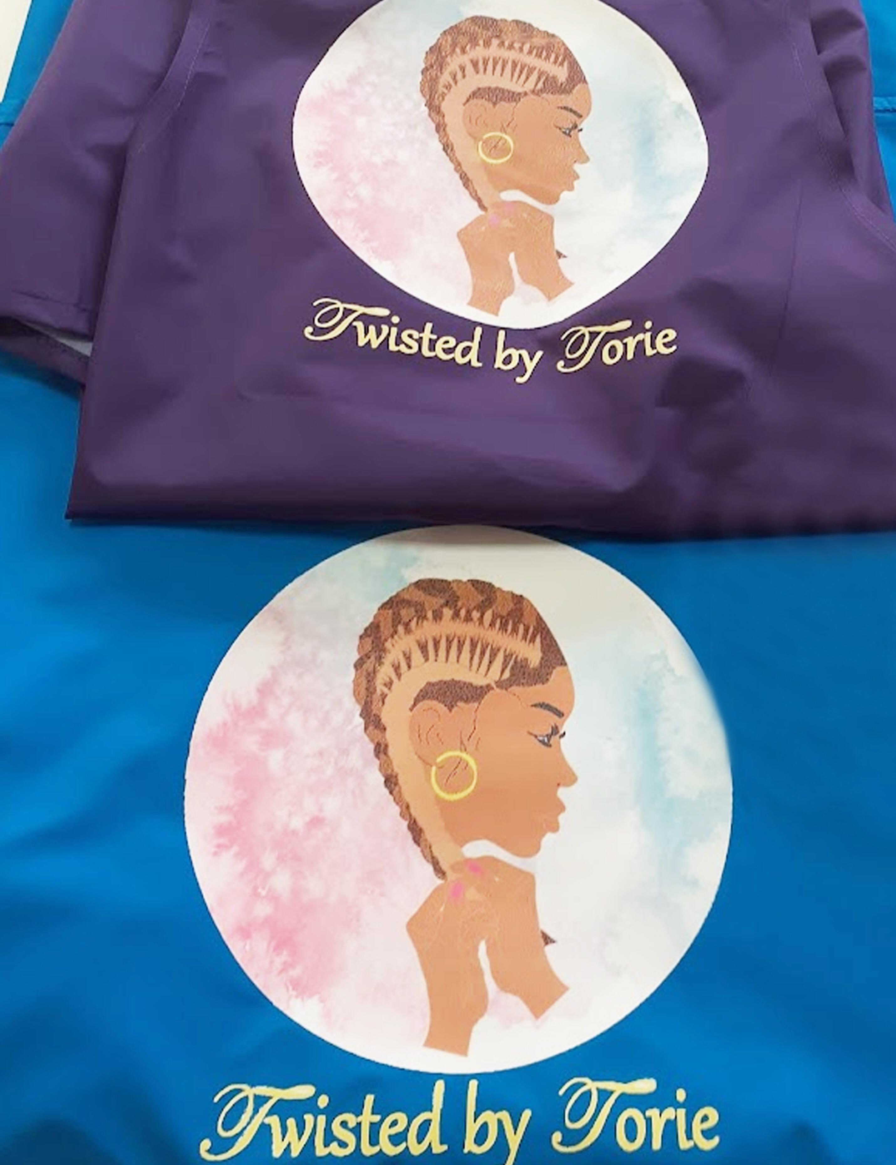 Personalized turquoise barber cape featuring custom-designed graphic prints.