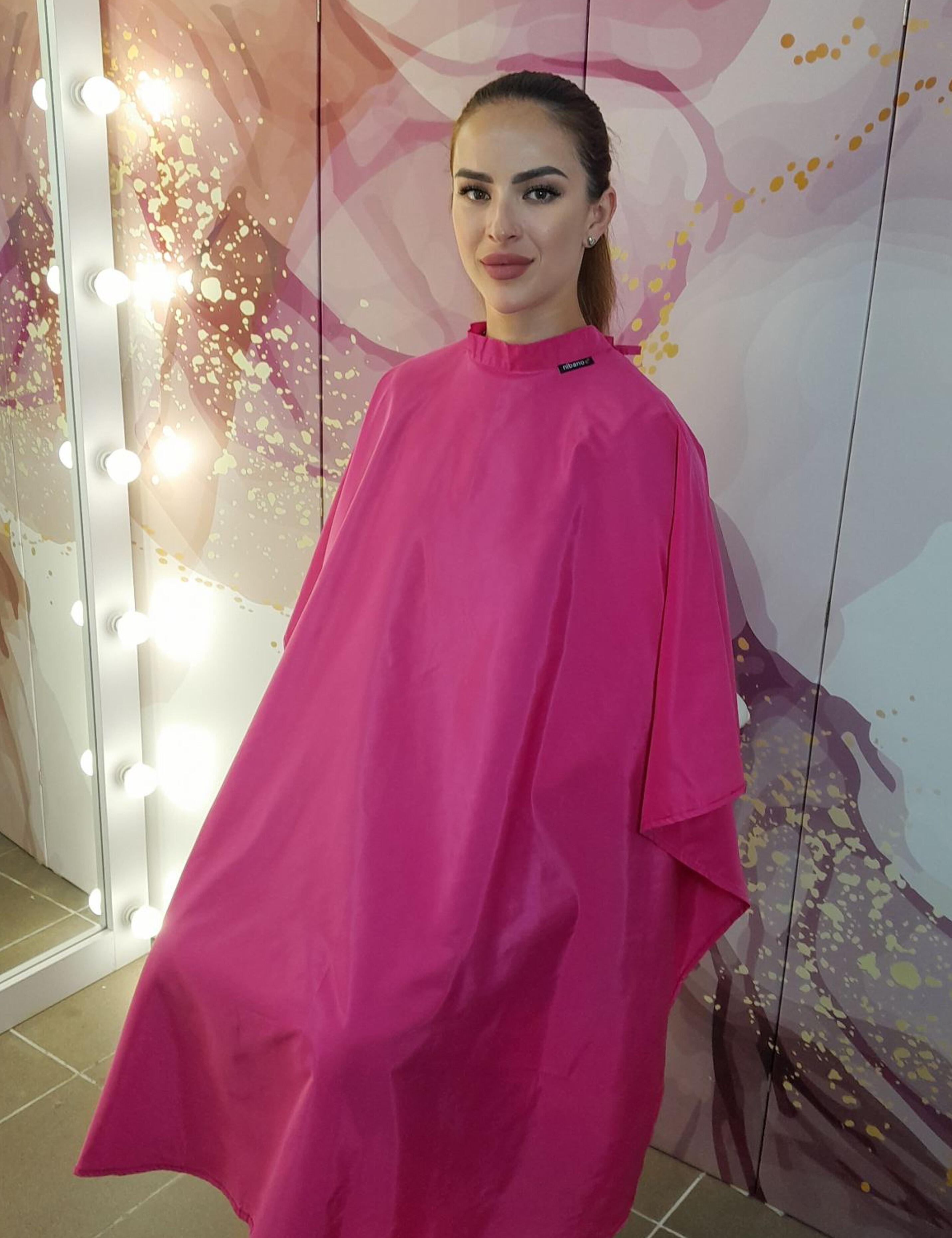 Aesthetic hot pink styling cape crafted for professional hairdressing and salon services