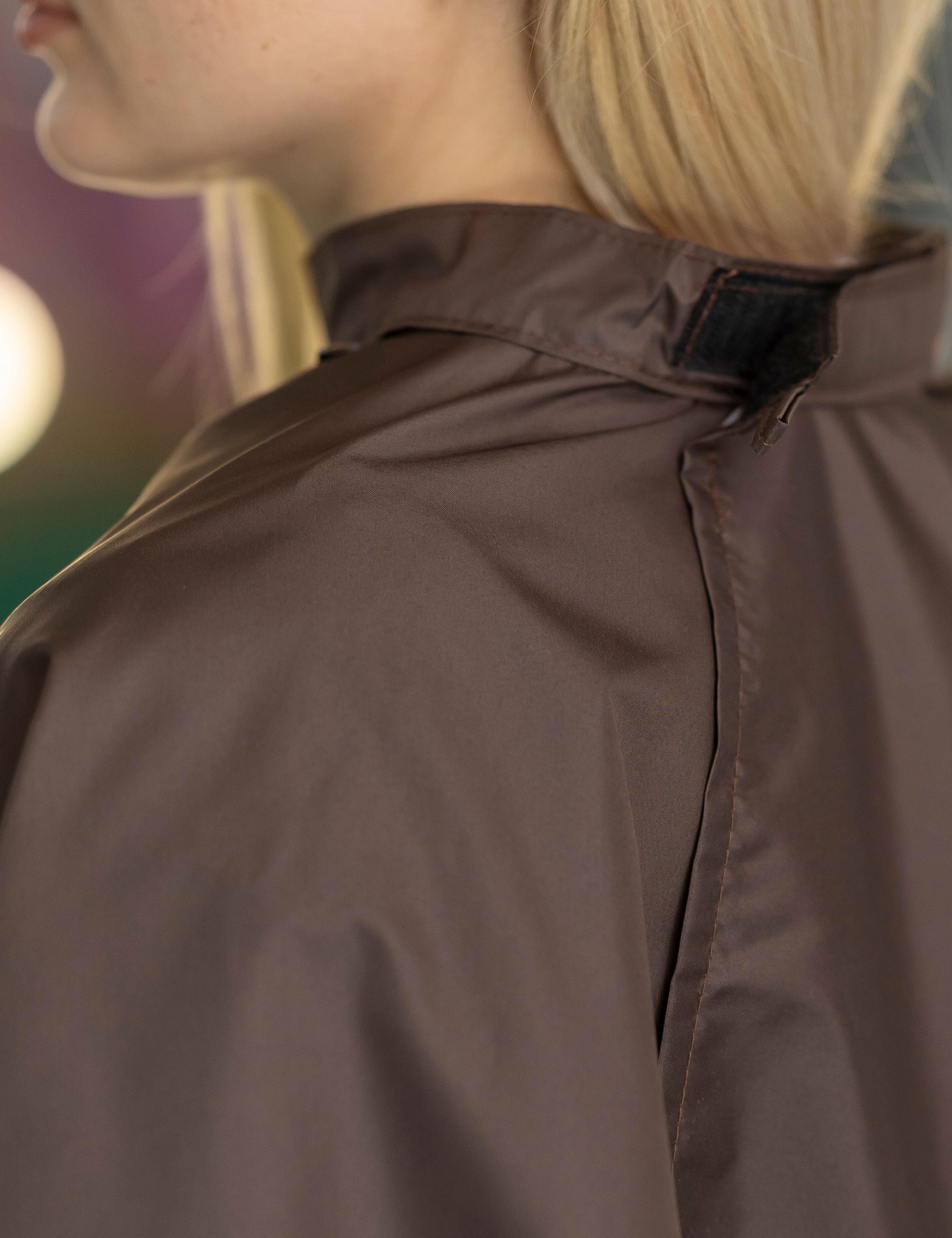 Chocolate color kids salon cape with a fully adjustable velcro neck line