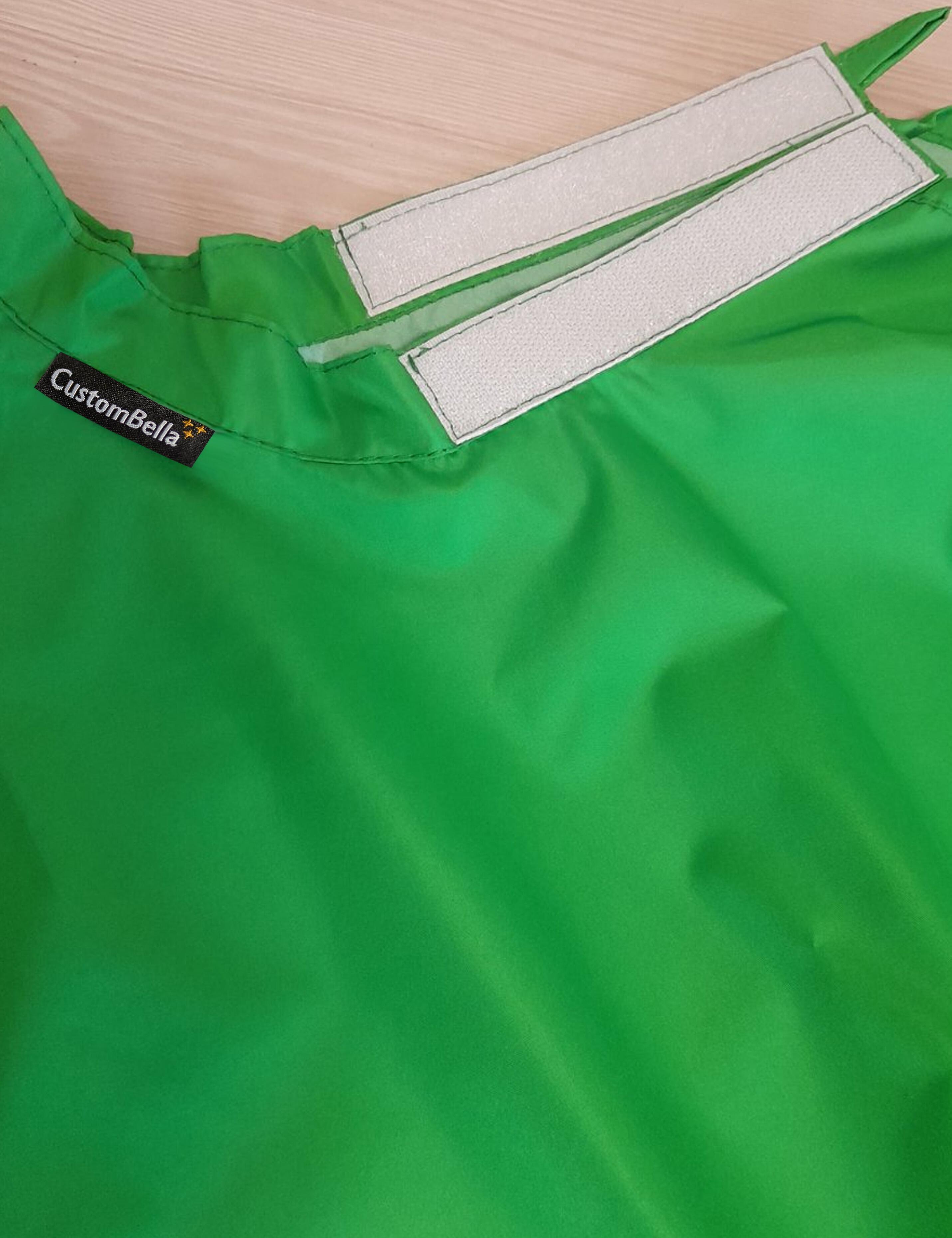 Kelly green kids salon cape with an adjustable velcro neck closure