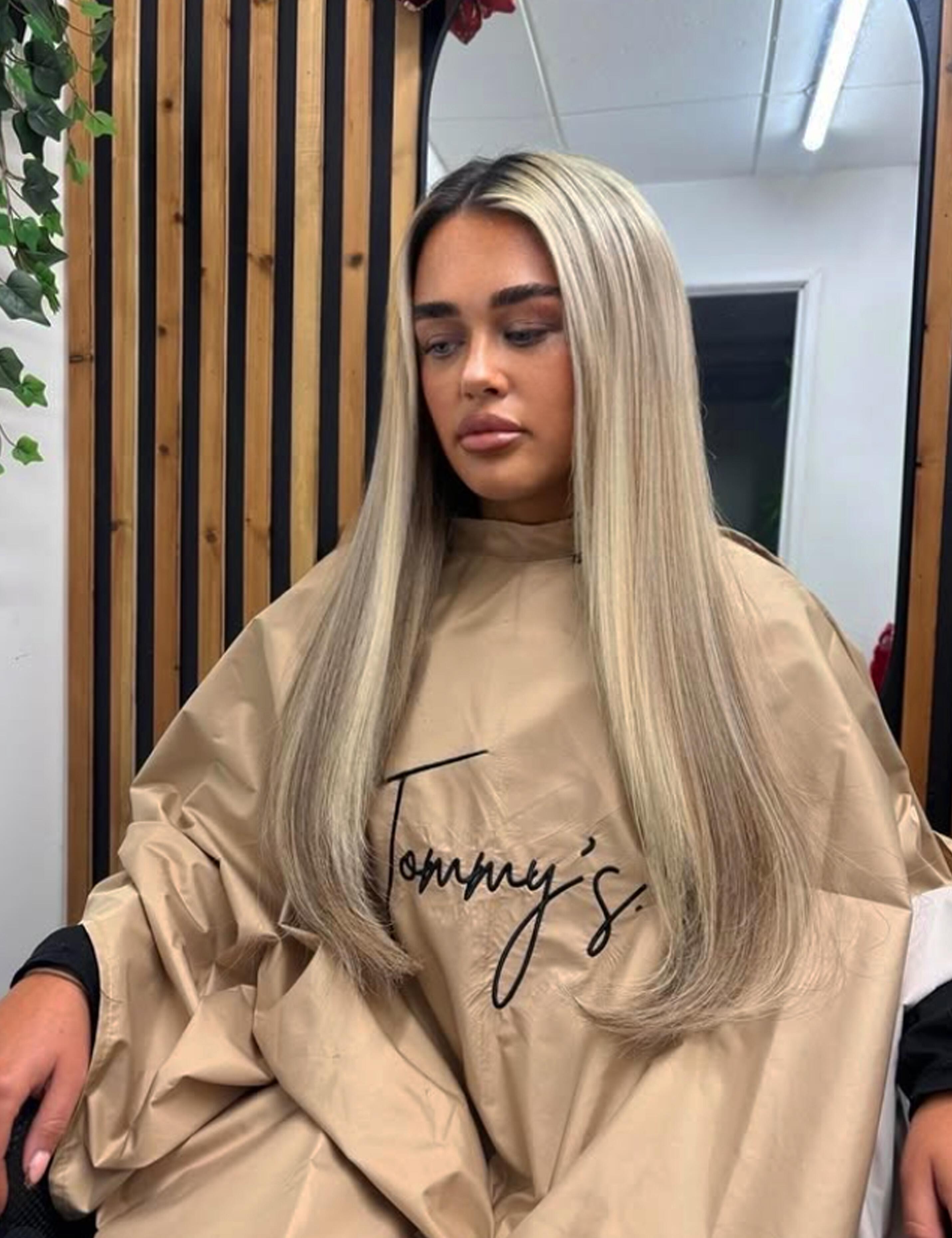Premium embroidered cappuccino salon cape featuring high-quality branding